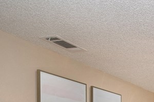 a bedroom with a large bed and a ceiling fan